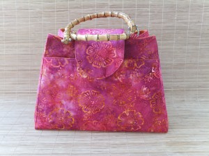 Pink and orange batik fabric used for custom order knitting bag with bamboo handles